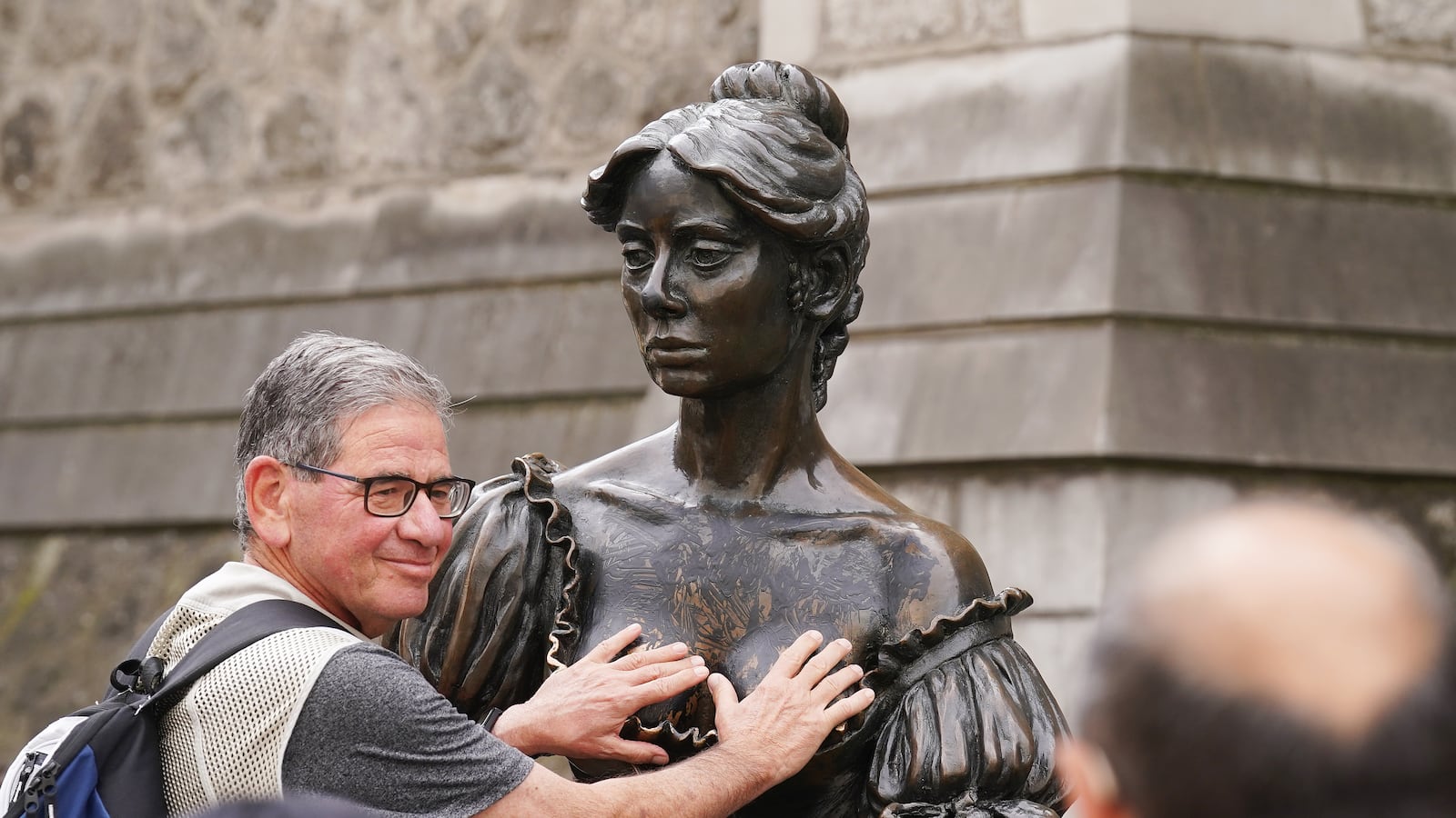 People pose for photographs with the iconic Molly Malone statue in Dublin's city centre after it was vandalised with black paint across it's front. The statue of the semi historical, semi-legendary figure is a popular tourist destination. Picture date: Wednesday August 16, 2023. (Photo by Brian Lawless/PA Images via Getty Images)