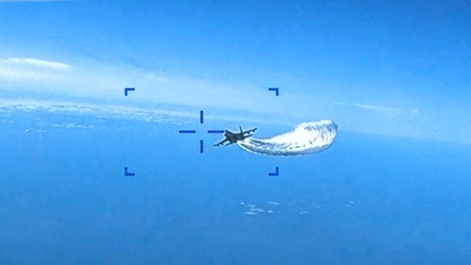 A Russian Su-27 military aircraft dumps fuel while flying toward a U.S. Air Force MQ-9 Reaper drone over the Black Sea, March 14, 2023.