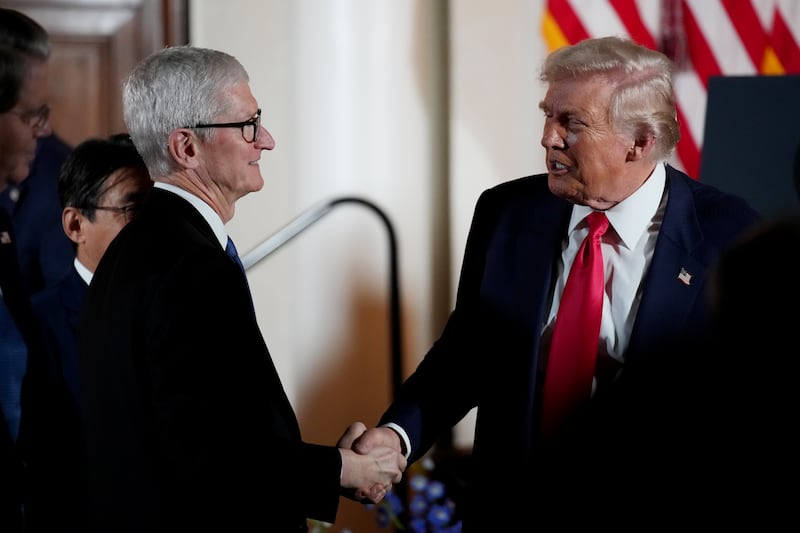 U.S. President Donald Trump shakes hands with Apple CEO Tim Cook during a meeting with business leaders at the U.S. Ambassador's Residence on October 28, 2025 in Tokyo, Japan.
