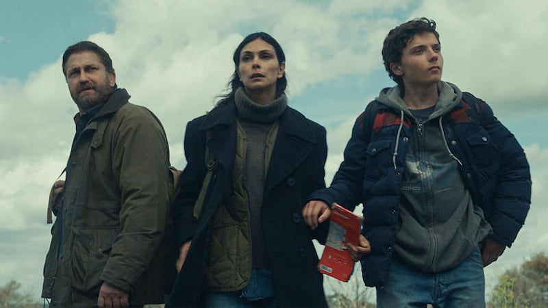 Gerard Butler as John Garrity, Morena Baccarin as Allison Garrity, and Roman Griffin Davis as Nathan Garrity in Greenland 2: Migration.