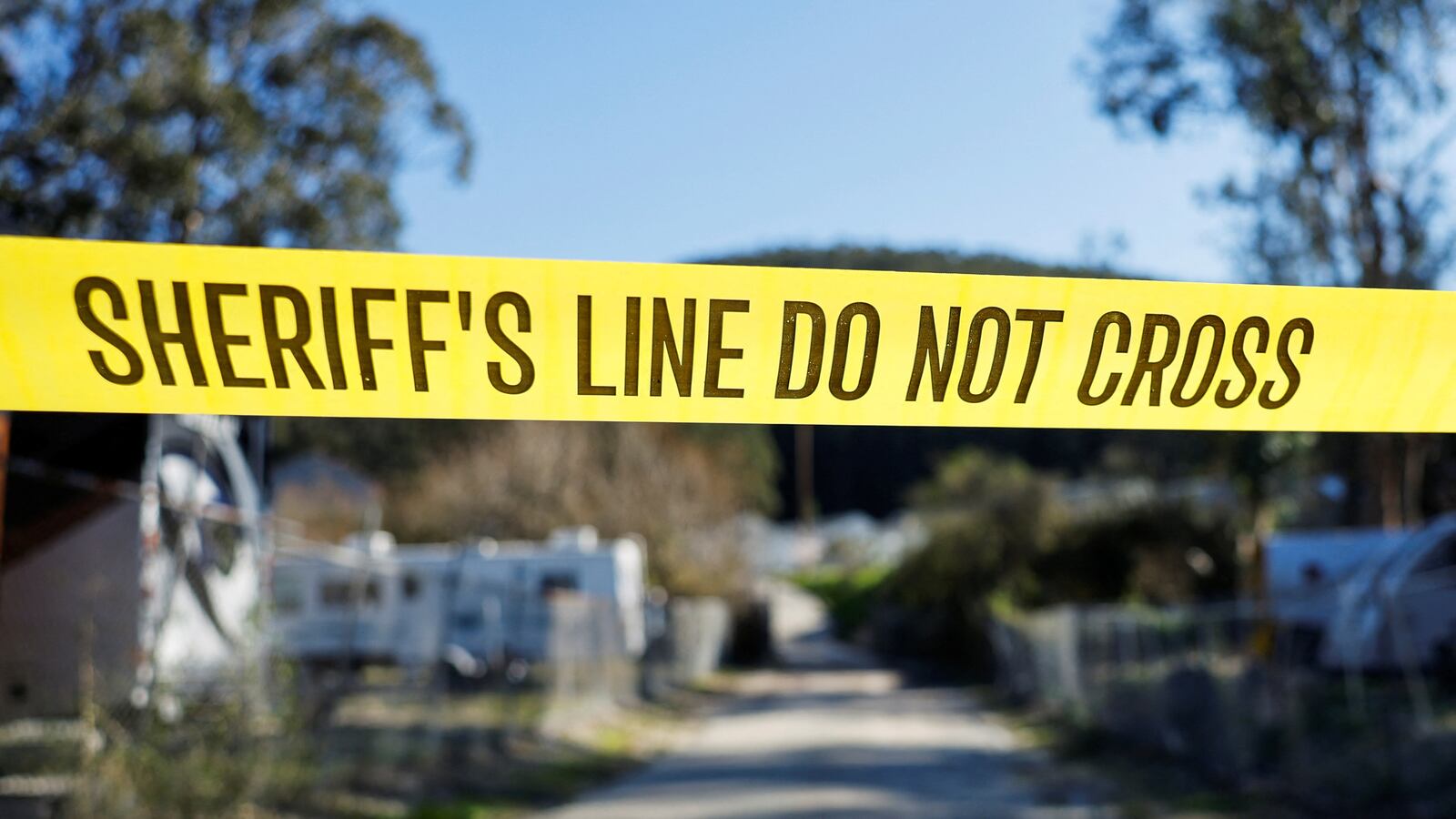 Police tape blocks off a crime scene, following a mass shooting at two locations in Half Moon Bay, California.