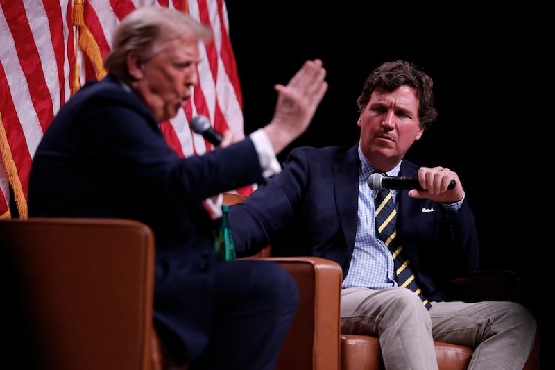 President Donald Trump sits down for a conversation with Tucker Carlson during his Live Tour at the Desert Diamond Arena on October 31, 2024 in Phoenix, Arizona.