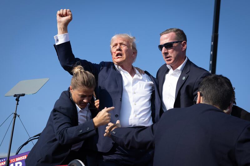 BUTLER, PENNSYLVANIA - JULY 13: Republican presidential candidate former President Donald Trump defiantly pumps his fist after being shot and rushed offstage during a rally on July 13, 2024 in Butler, Pennsylvania. Butler County district attorney Richard Goldinger said the gunman was shot and killed after injuring former U.S. President Donald Trump, killing one audience member and critically injuring two others in the shooting.  (Photo by Anna Moneymaker/Getty Images)