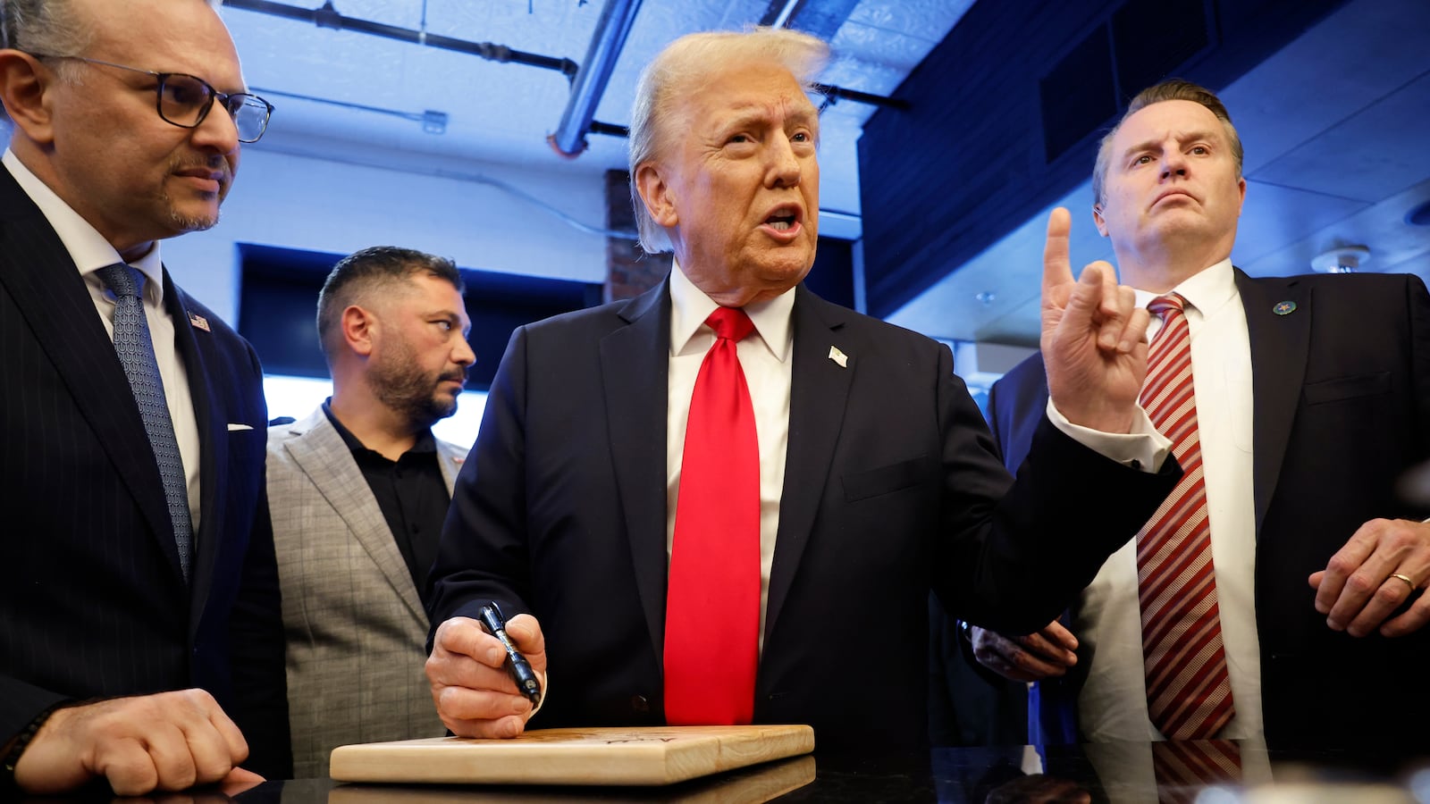 Donald Trump signs autographs in November.