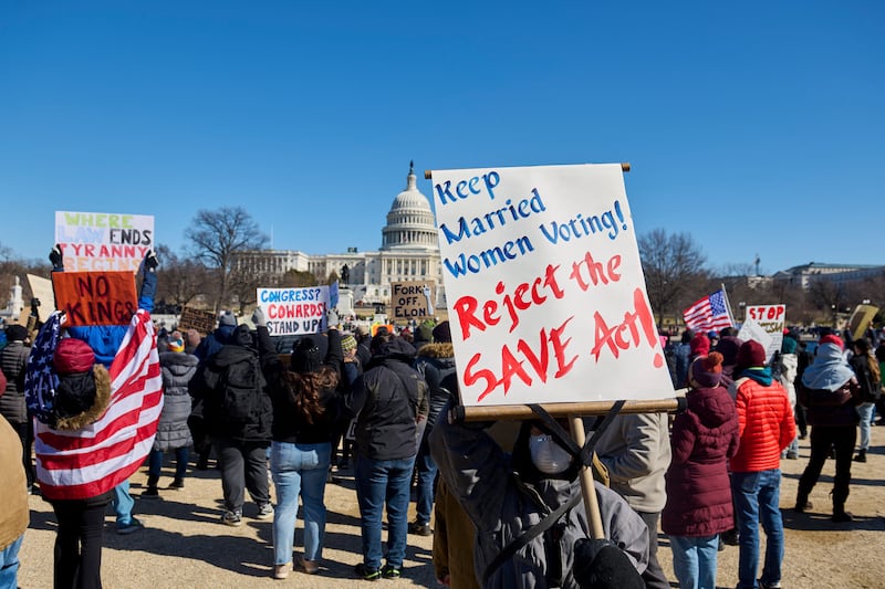 People participate in a protest against the Trump administration's mass firing of government workers and civil servants in front of the Capitol building in Washington D.C. on Presidents' Day, Feb. 17, 2025. (Photo by Dominic Gwinn / Middle East Images / Middle East Images via AFP) (Photo by DOMINIC GWINN/Middle East Images/AFP via Getty Images)