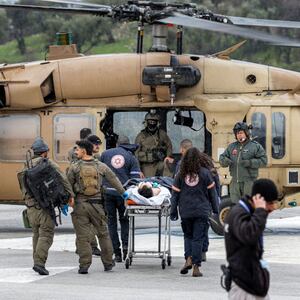 An Israeli medical team transports a person wounded in a rocket attack fired from southern Lebanon at Ziv hospital in Israel’s northern city of Safed on February 14, 2024.