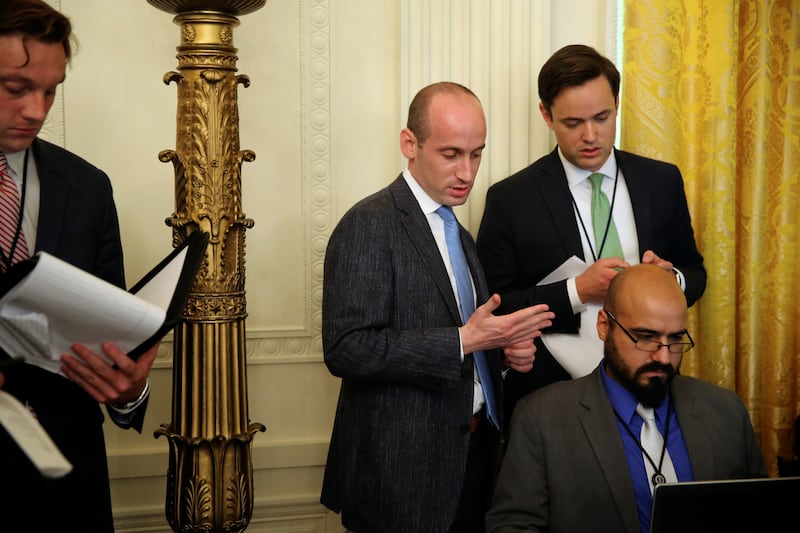 White House policy advisor Stephen Miller works with Gabriel Perez on President Donald Trump's remarks before a meeting of the National Space Council at the White House in Washington on June 18, 2018.