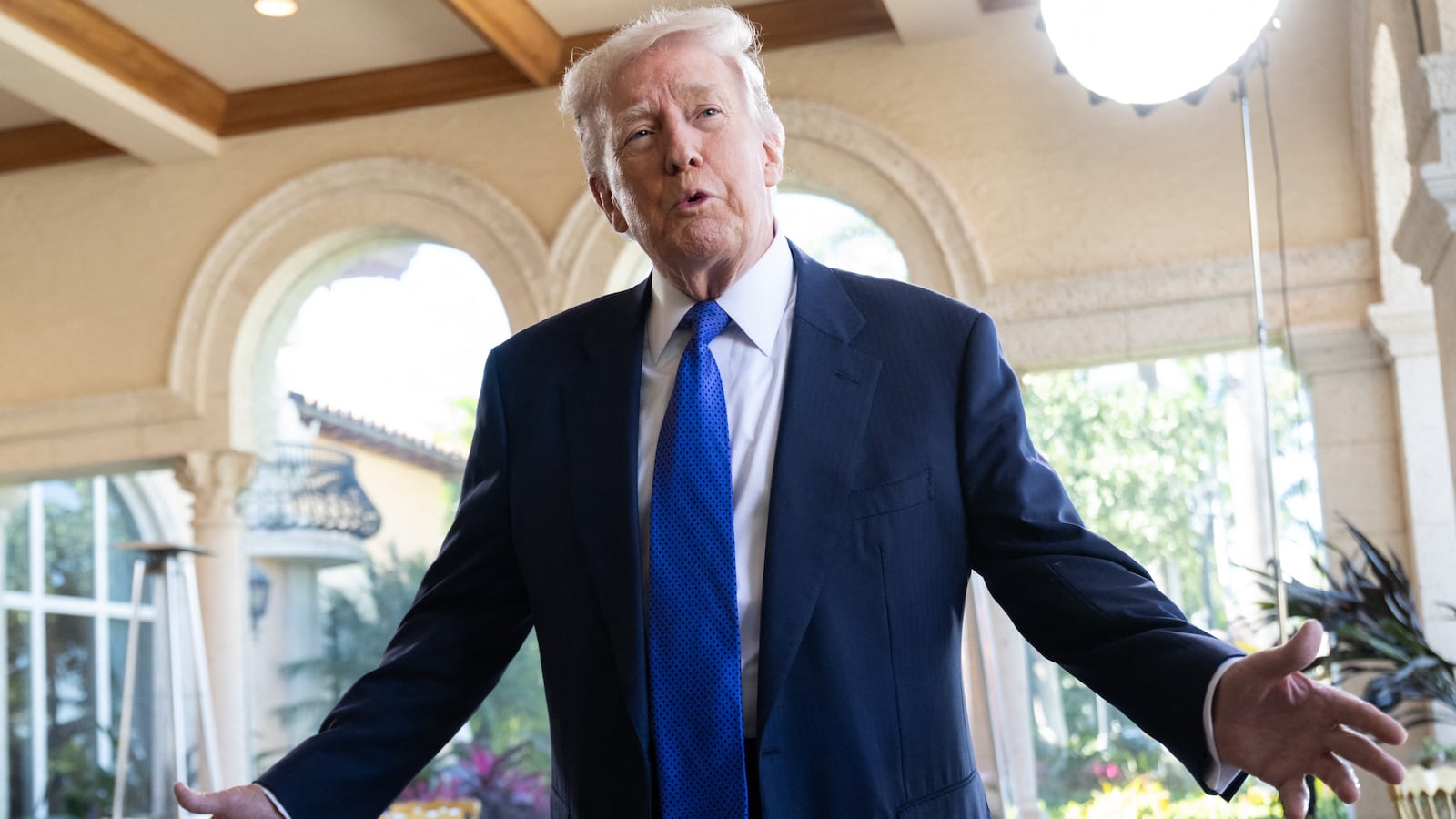 US President Donald Trump speaks to the press as he arrives to attend the wedding of Dan Scavino, White House Deputy Chief of Staff, and Erin Elmore, the Department of State Director of Art in Embassies, at Mar-a-Lago in Palm Beach, Florida, February 1, 2026. (Photo by SAUL LOEB / AFP via Getty Images)