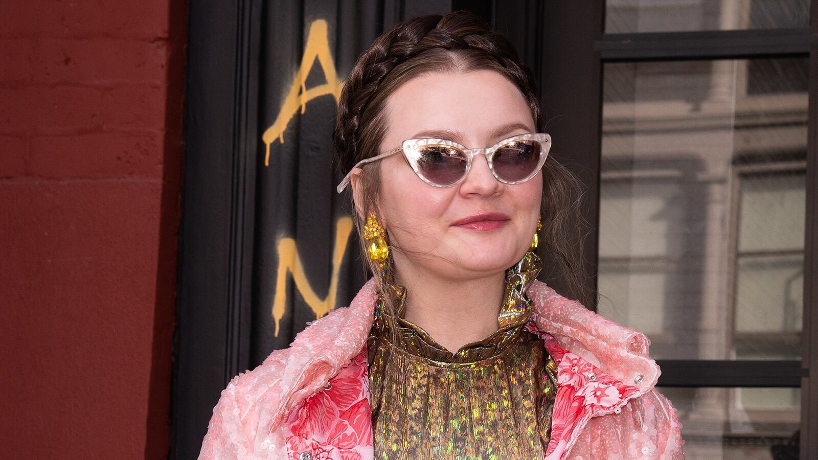 Anna Sorokin in sunglasses and a pink coat
