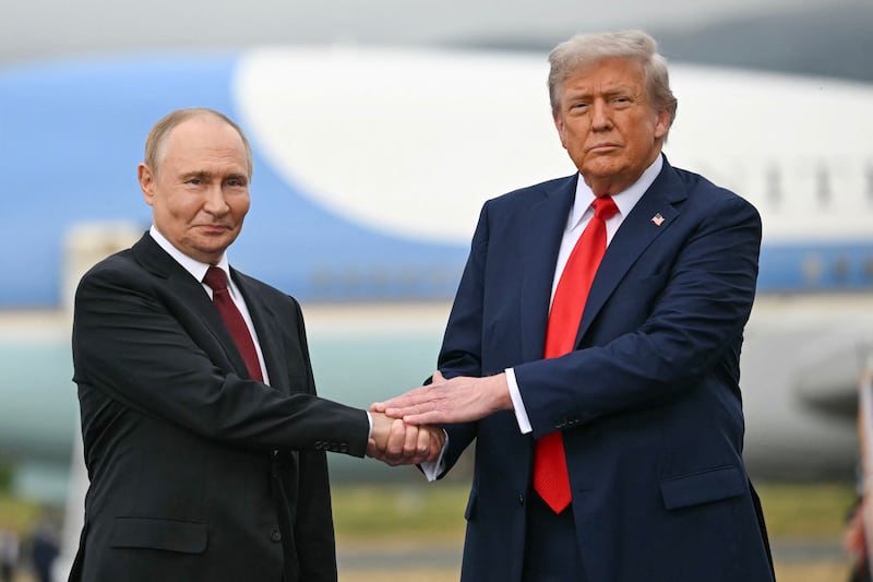 TOPSHOT - US President Donald Trump greets Russian President Vladimir Putin on the tarmac after they arrived at Joint Base Elmendorf-Richardson in Anchorage, Alaska, on August 15, 2025. Putin is in Alaska at the invitation of Trump in his first visit to a Western country since he ordered the 2022 invasion of Ukraine that has killed tens of thousands of people. (Photo by ANDREW CABALLERO-REYNOLDS / AFP) (Photo by ANDREW CABALLERO-REYNOLDS/AFP via Getty Images)