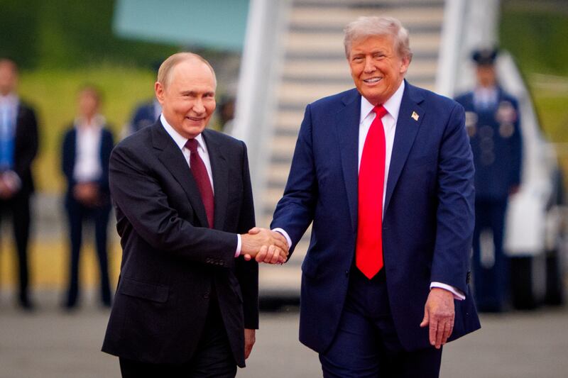 ANCHORAGE, ALASKA - AUGUST 15: (EDITOR'S NOTE: Alternate Crop) U.S. President Donald Trump (R) greets Russian President Vladimir Putin as he arrives at Joint Base Elmendorf-Richardson on August 15, 2025 in Anchorage, Alaska. The two leaders are meeting for peace talks aimed at ending the war in Ukraine. (Photo by Andrew Harnik/Getty Images)