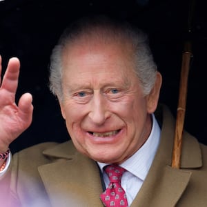 King Charles III shelters under an umbrella as he meets members of the public during a walkabout after visiting The Sun Inn on February 5, 2026 in Dedham, Essex.