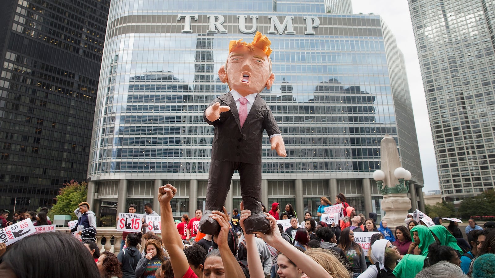 Demonstrators hold up a piñata of Donald Trump during a protest outside Trump Tower in Chicago