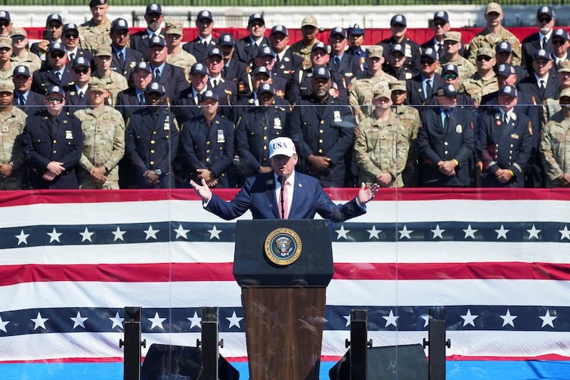 U.S. President Donald Trump speaks, while standing behind protective glass, during the Steel Across America event featuring a 21-foot steel beam recovered from the World Trade Centre South Tower, on the Ellipse near the White House in Washington, D.C., U.S., September 8, 2026. REUTERS/Nathan Howard