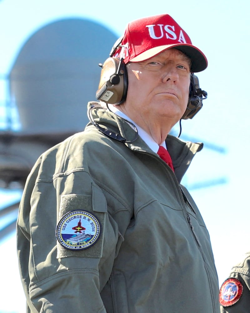 U.S. President Donald Trump looks on aboard the aircraft carrier USS George H.W. Bush during U.S. Navy sea power demonstrations off the coast of Norfolk, Virginia, U.S. October 5, 2025.