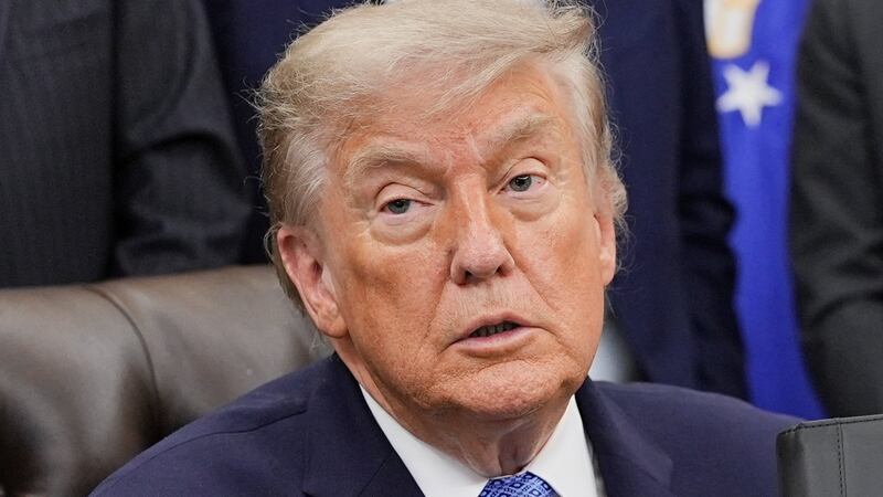 U.S. President Donald Trump receives the report from his Religious Liberty Commission in the Oval Office of the White House in Washington, D.C., U.S., June 26, 2026. REUTERS/Ken Cedeno