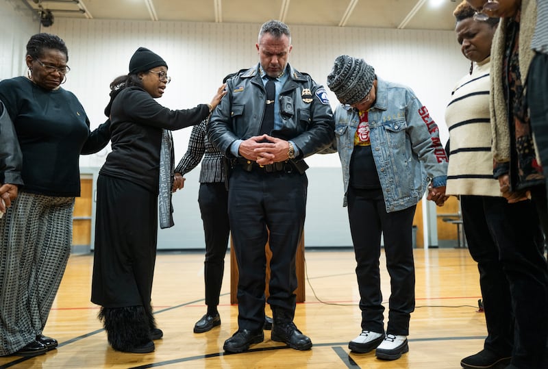 June Pierce (L) prays over Minneapolis Police Chief Brian O'Hara (C) during an interfaith prayer for the Somali community of Minnesota at Brian Coyle Community Center on December 4, 2025 in Minneapolis, Minnesota.