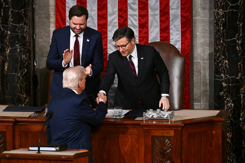 President Donald Trump shakes hands with House Speaker Mike Johnson (R-La.) as Vice President JD Vance looks on.