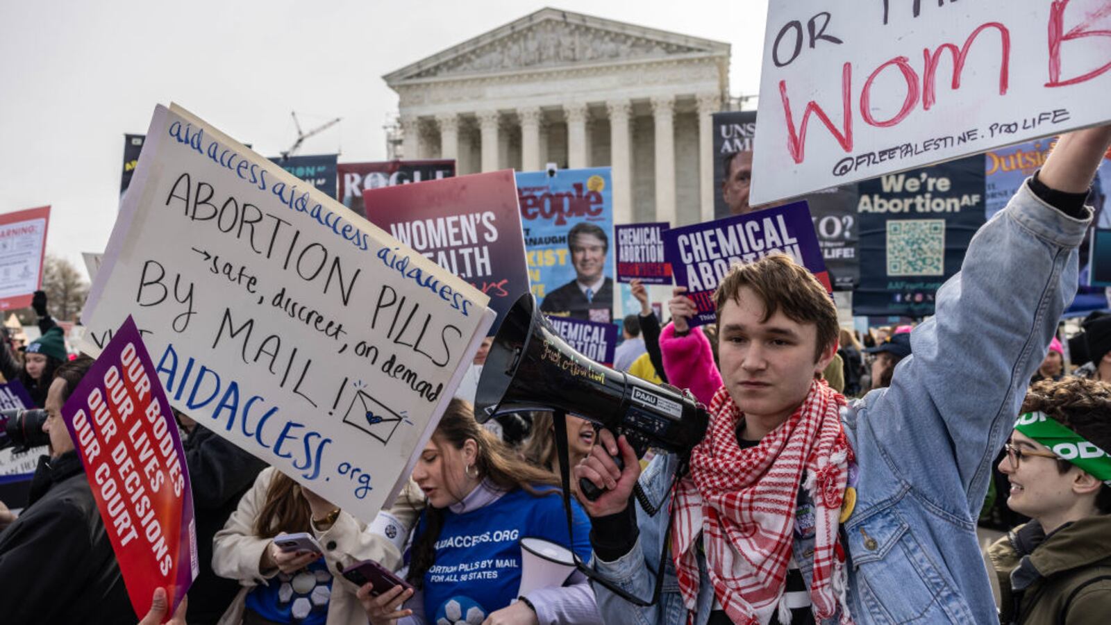 Demonstrators gather in front of the Supreme Court