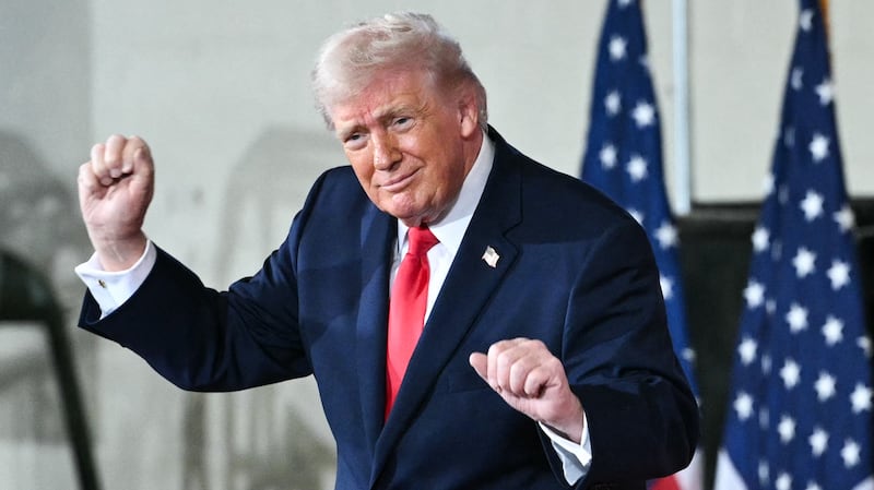 Donald Trump dances on stage next to Melania