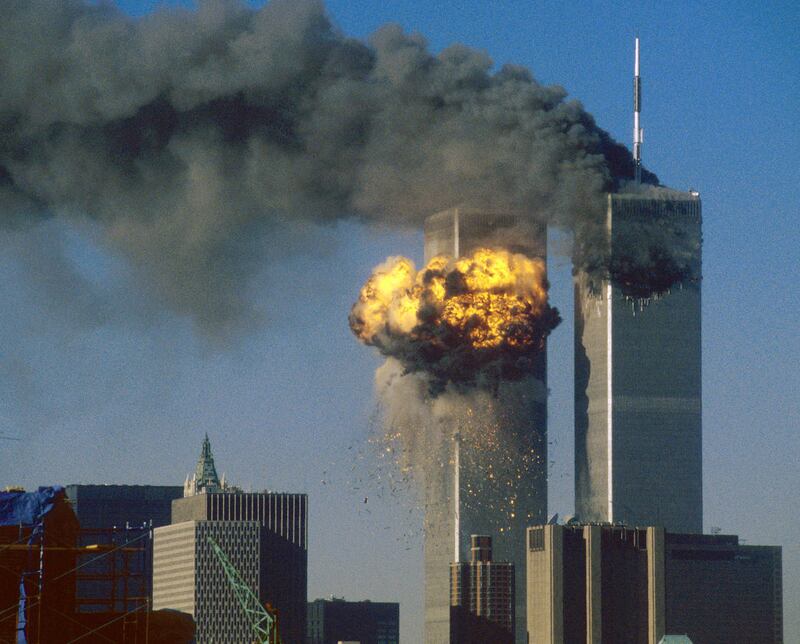 The World Trade Center south tower (L) burst into flames after being struck by hijacked United Airlines Flight 175, as the north tower burned following an earlier attack by a hijacked airliner in New York City, September 11, 2001.