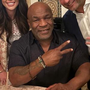 Mike Tyson poses with guests at President-elect Donald Trump's Mar-a-Lago estate.
