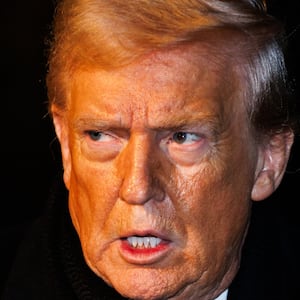 President Donald Trump walks over to reporters to make a brief statement before departing from the South Lawn of the White House in Marine One on January 20, 2026 in Washington, DC.