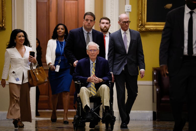 Sen. Mitch McConnell (R-KY) sits in a wheelchair, as he is pushed on his way to speak to reporters outside the Senate Chamber after he returned to Capitol Hill in Washington, D.C., on Sept. 14, 2026.