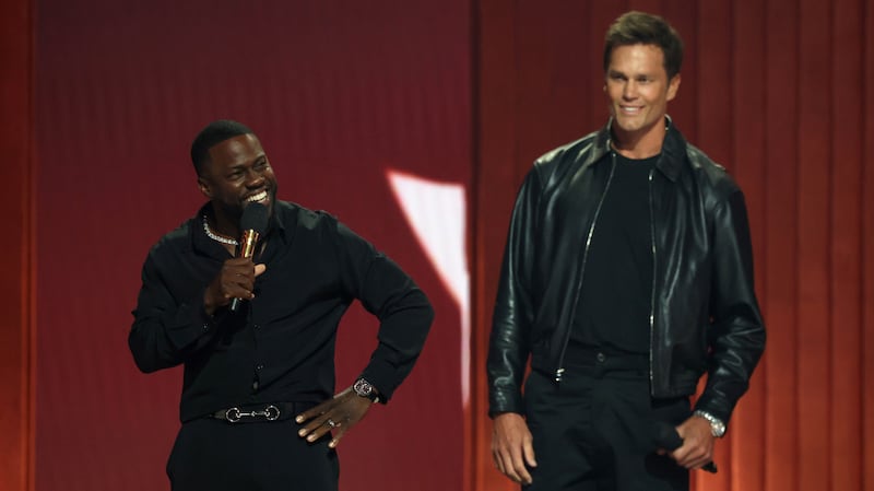 Kevin Hart and Tom Brady speak onstage during Netflix Is A Joke Festival Presents: The Roast of Kevin Hart at The Kia Forum on May 10, 2026, in Inglewood, California.