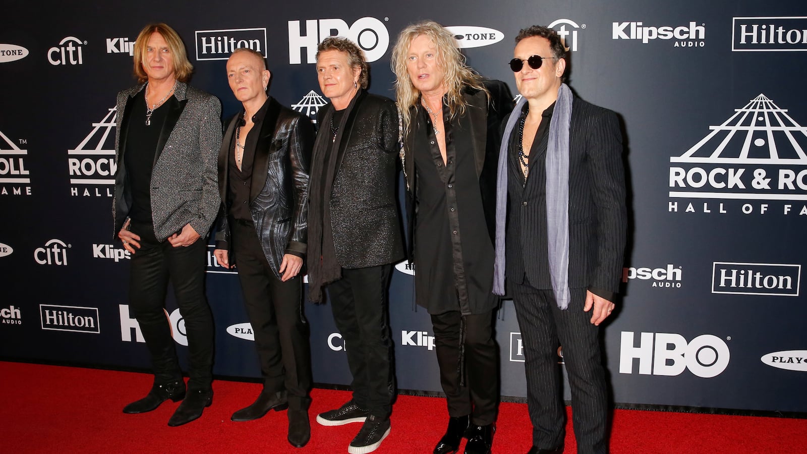 Def Leppard members Joe Elliott, Phil Collen, Rick Allen, Rick Savage and Vivian Campbell on a red carpet