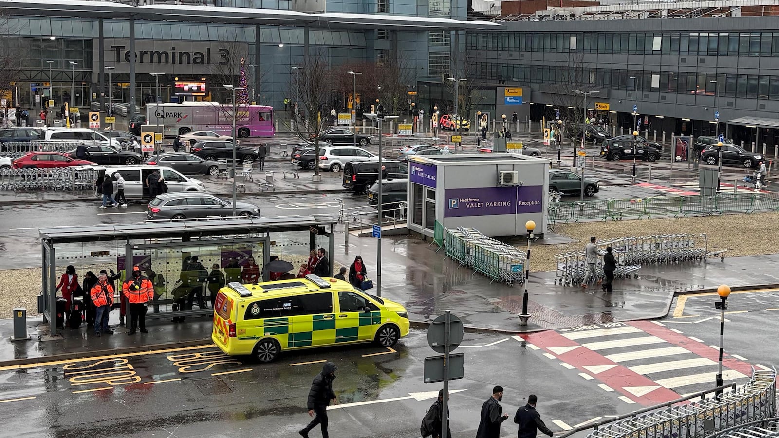 An emergency vehicle outside Heathrow Terminal 3 after a man has been arrested on suspicion of assault after number of people were attacked with "a form of pepper spray" by a group of men at a car park at Heathrow Airport, police said. Picture date: Sunday December 7, 2025.