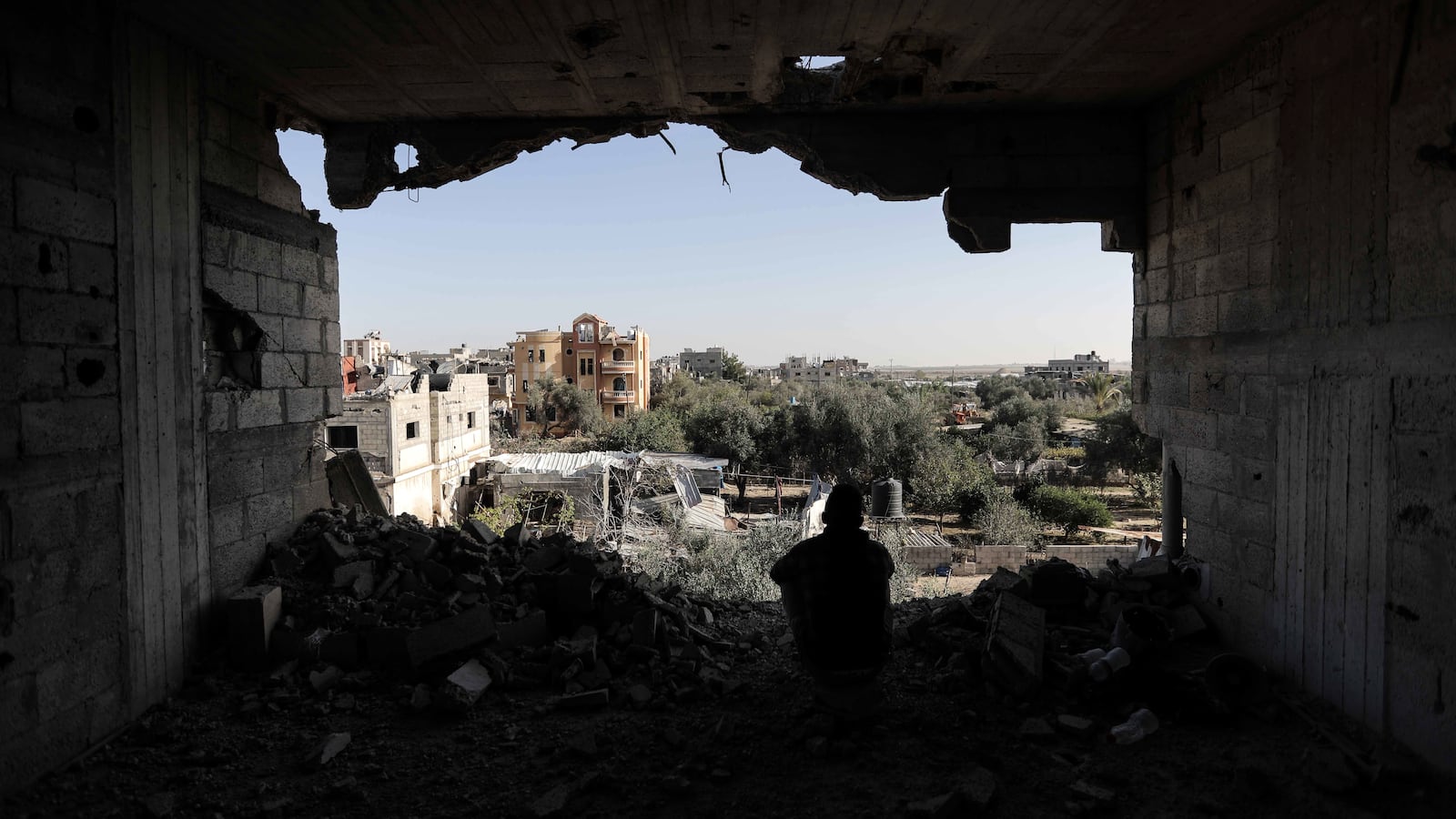 A photograph of a Palestinian citizens inspecting the effects of destruction caused by air strikes on their homes in the Khuza’a area on November 24, 2023 in Khan Yunis, Gaza.