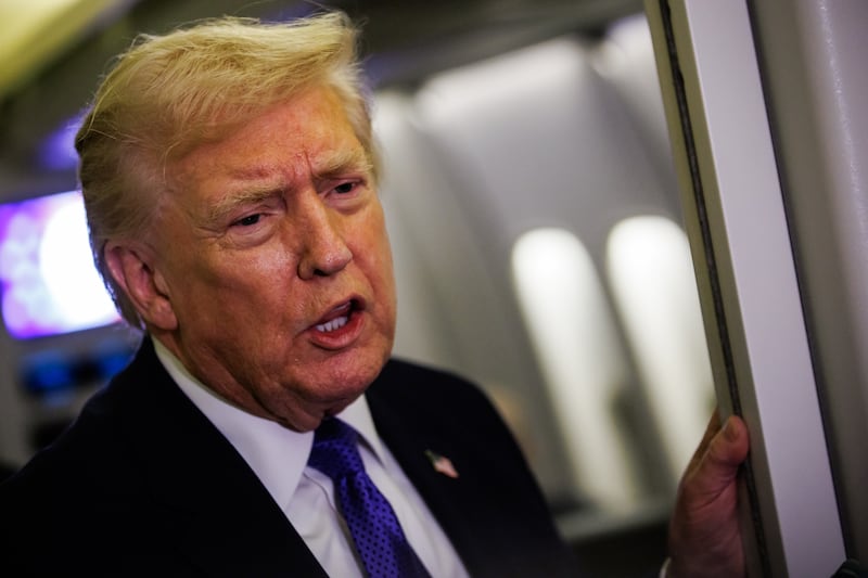 IN FLIGHT - FEBRUARY 06: U.S. President Donald Trump gaggles with reporters while aboard Air Force One on February 6, 2026 en route to Palm Beach, Florida. The President is spending the weekend at Mar-a-Lago, his private club. (Photo by Samuel Corum/Getty Images)