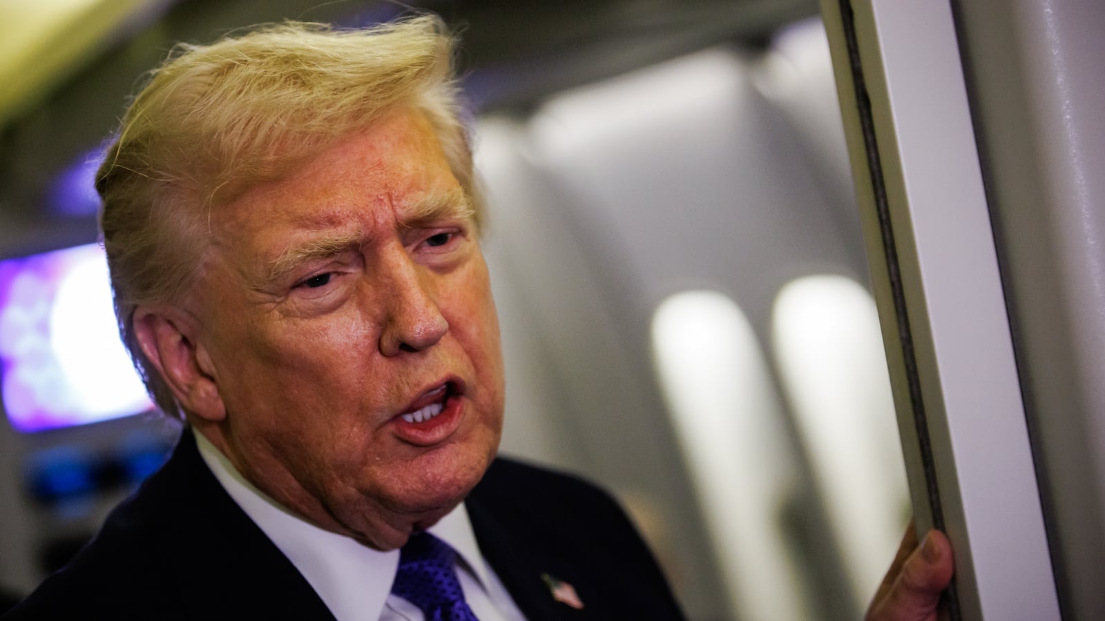 IN FLIGHT - FEBRUARY 06: U.S. President Donald Trump gaggles with reporters while aboard Air Force One on February 6, 2026 en route to Palm Beach, Florida. The President is spending the weekend at Mar-a-Lago, his private club. (Photo by Samuel Corum/Getty Images)