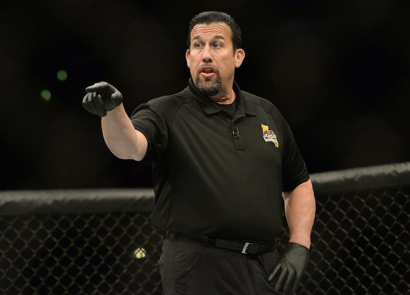 Referee John McCarthy separates Roman Salazar (not pictured) during his Bantamweight bout against Kid Yamamoto