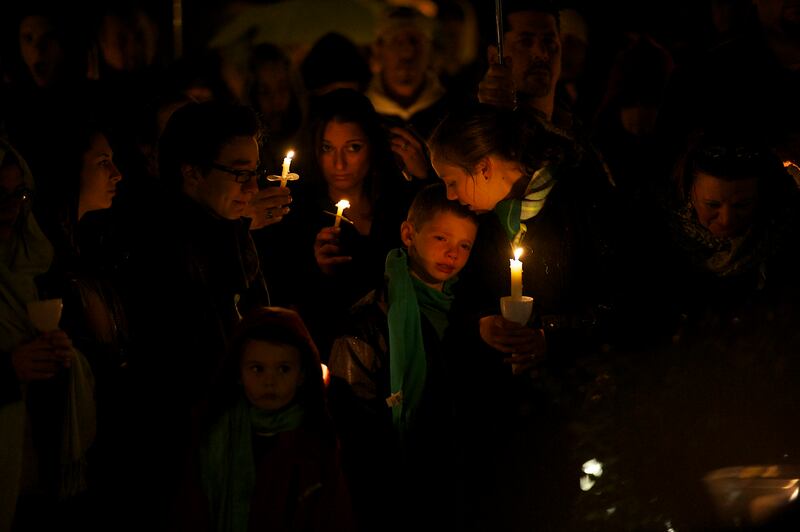 Family members gather for a candlelight vigil in honor of Sandy Hook Elementary School Principal Dawn Hochsprung on December 18, 2012, in Naugatuck, CT, 4 days after a mass shooting of 20 children and 7 adults at Sandy Hook Elementary School. (Photo by Mark Makela/Corbis via Getty Images)