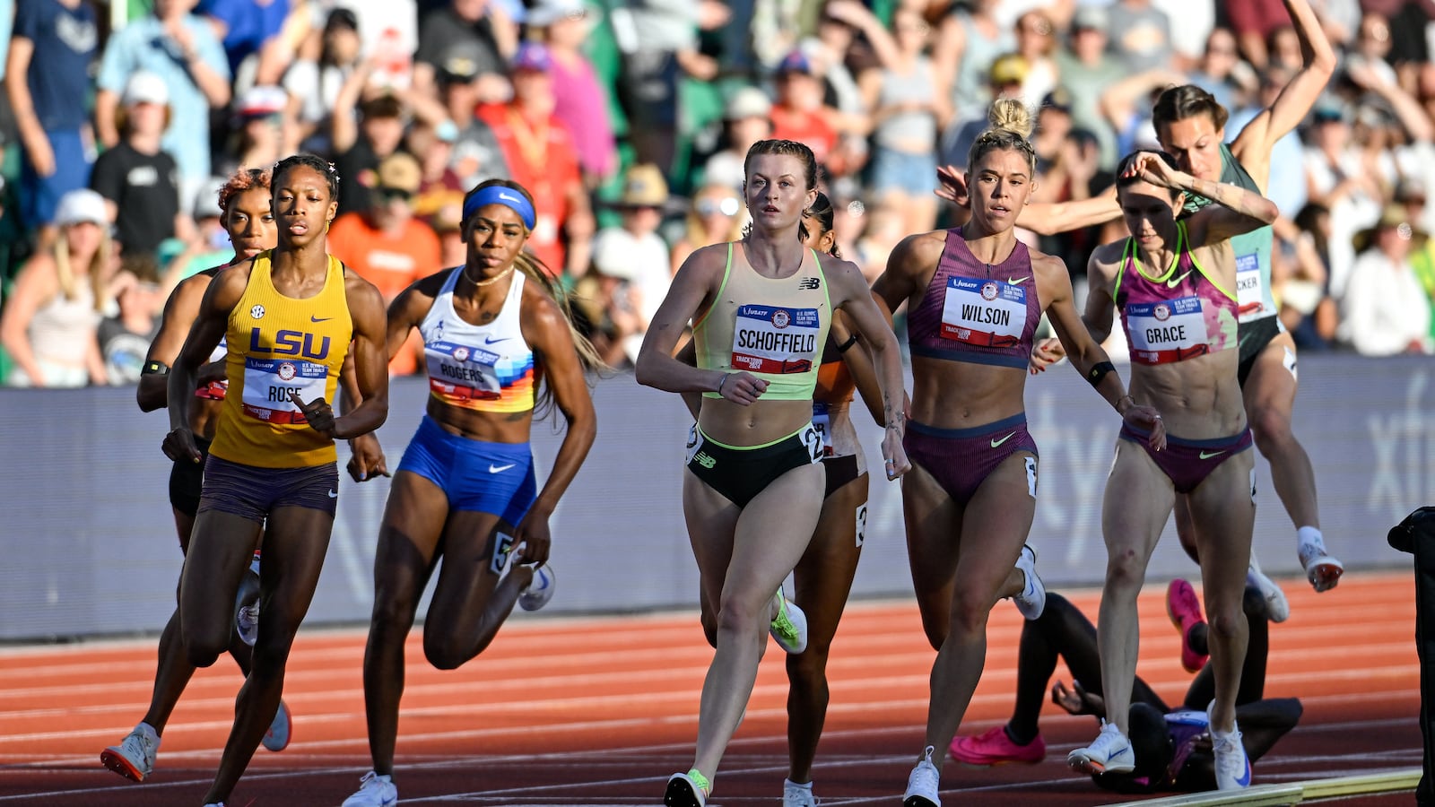 800 meter runners try to avoid fallen runner Athing Mu (back).
