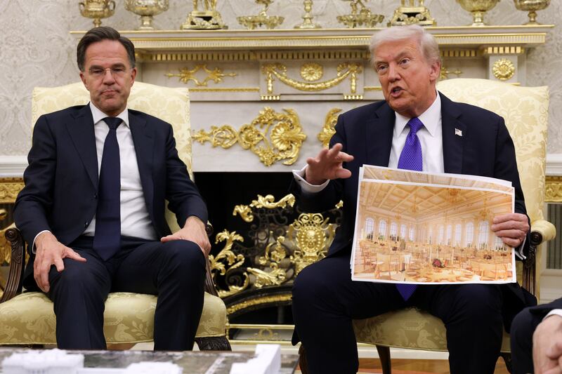 WASHINGTON, DC - OCTOBER 22: U.S. President Donald Trump displays a rendering of his proposed $250 million White House ballroom as he meets with NATO Secretary General Mark Rutte (L) in the Oval Office of the White House on October 22, 2025 in Washington, DC. Less than a week after hosting Ukrainian President Volodymyr Zelensky, Trump is meeting with Rutte to discuss the war in Ukraine. (Photo by Alex Wong/Getty Images)