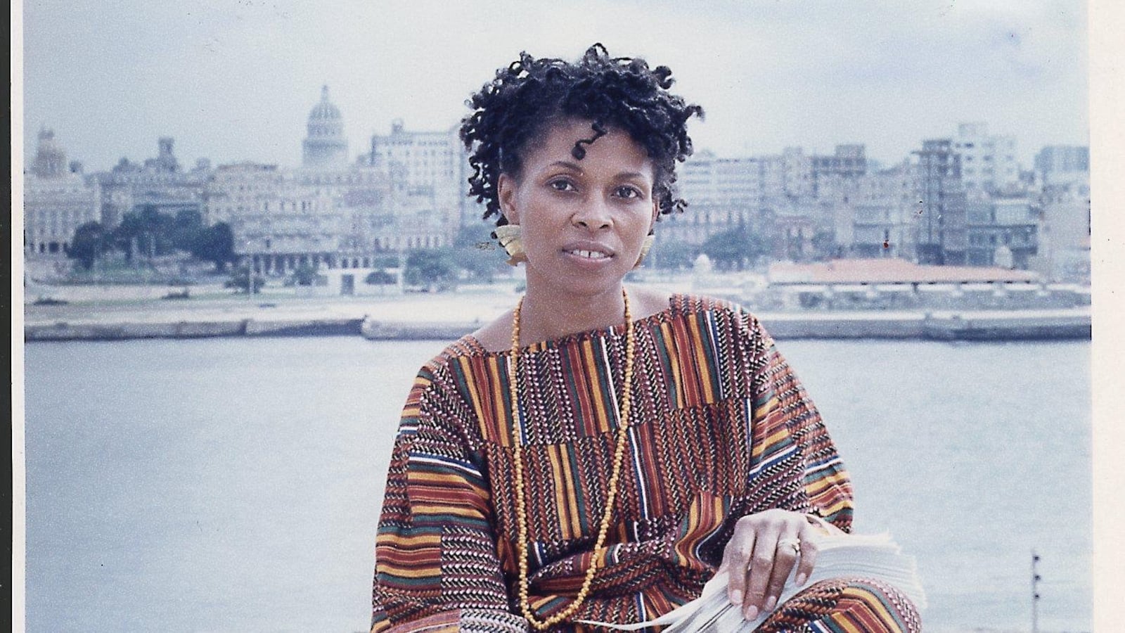Havana, Cuba: JoAnn Chesimard, aka Assata Shakur, holding the manuscript of her autobiography with Old Havana, Cuba, in the background on October 7, 1987. (Photo by Ozier Muhammad/Newsday RM via Getty Images)