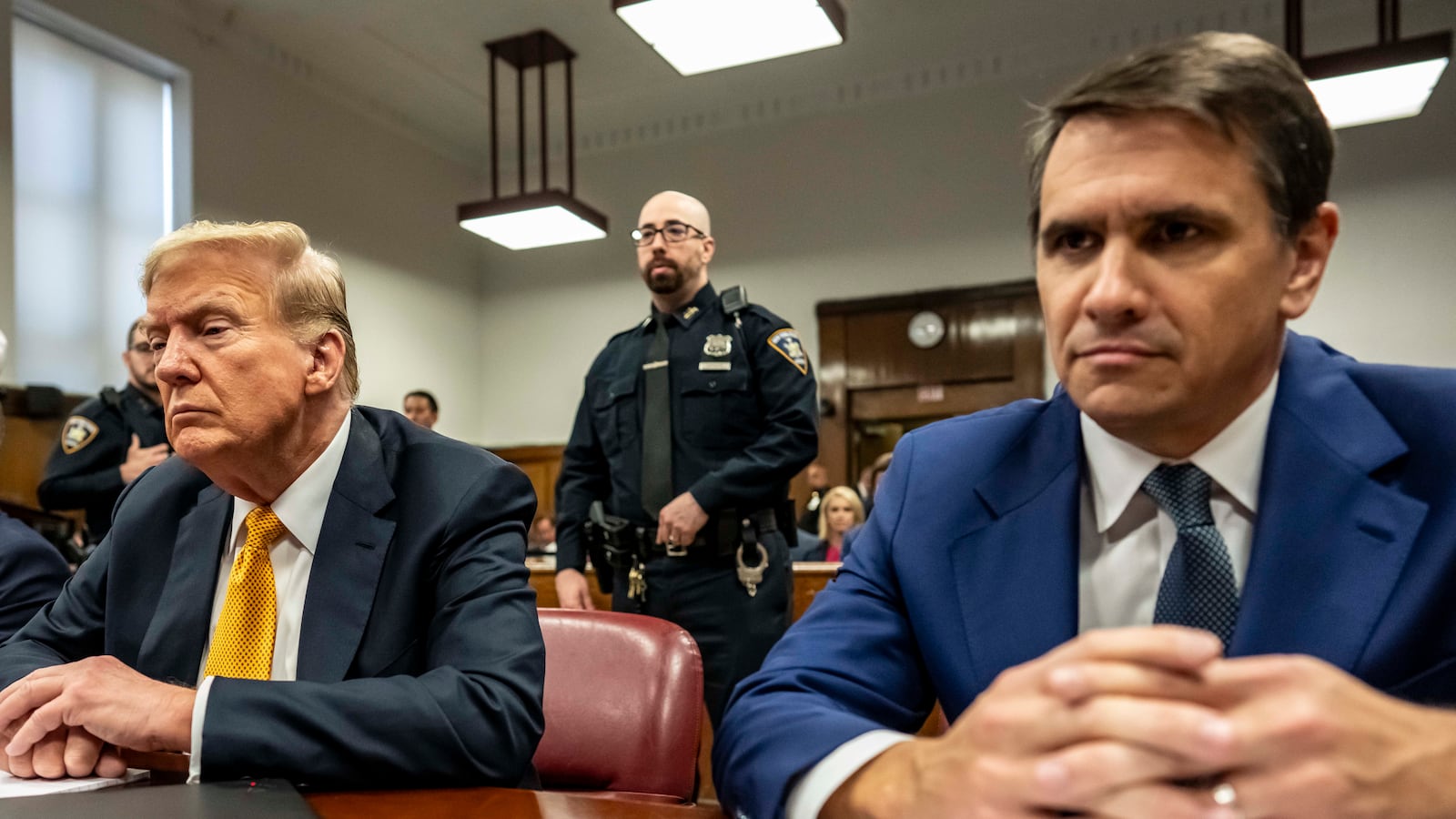 Former U.S. President Donald Trump appears in court with attorneys Emil Bove (L) and Todd Blanche (R) for his trial for allegedly covering up hush money payments at Manhattan Criminal Court on May 21, 2024 in New York City.