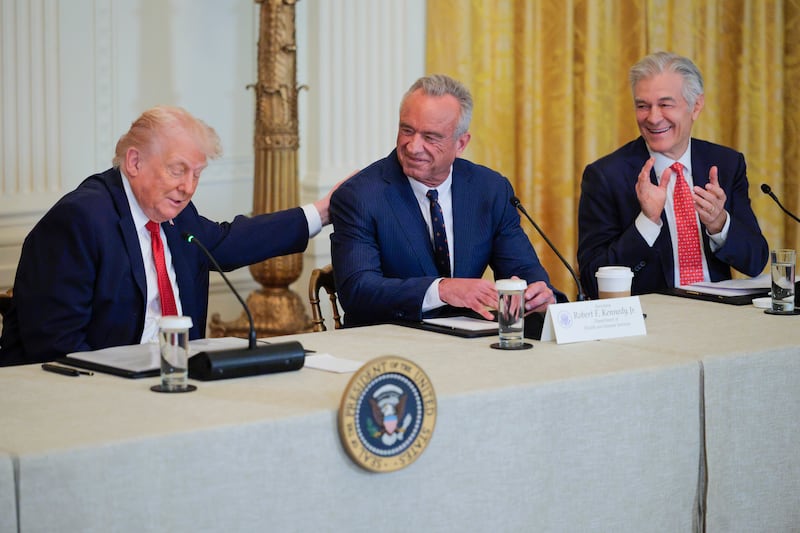 U.S. President Donald Trump speaks as U.S. Secretary of Health and Human Services Robert F. Kennedy Jr. and Administrator for the Centers for Medicare & Medicaid Services Mehmet Oz react during a "Great, Historic Investment in Rural Health Roundtable" in the East Room of the White House on January 16, 2026 in Washington, DC.