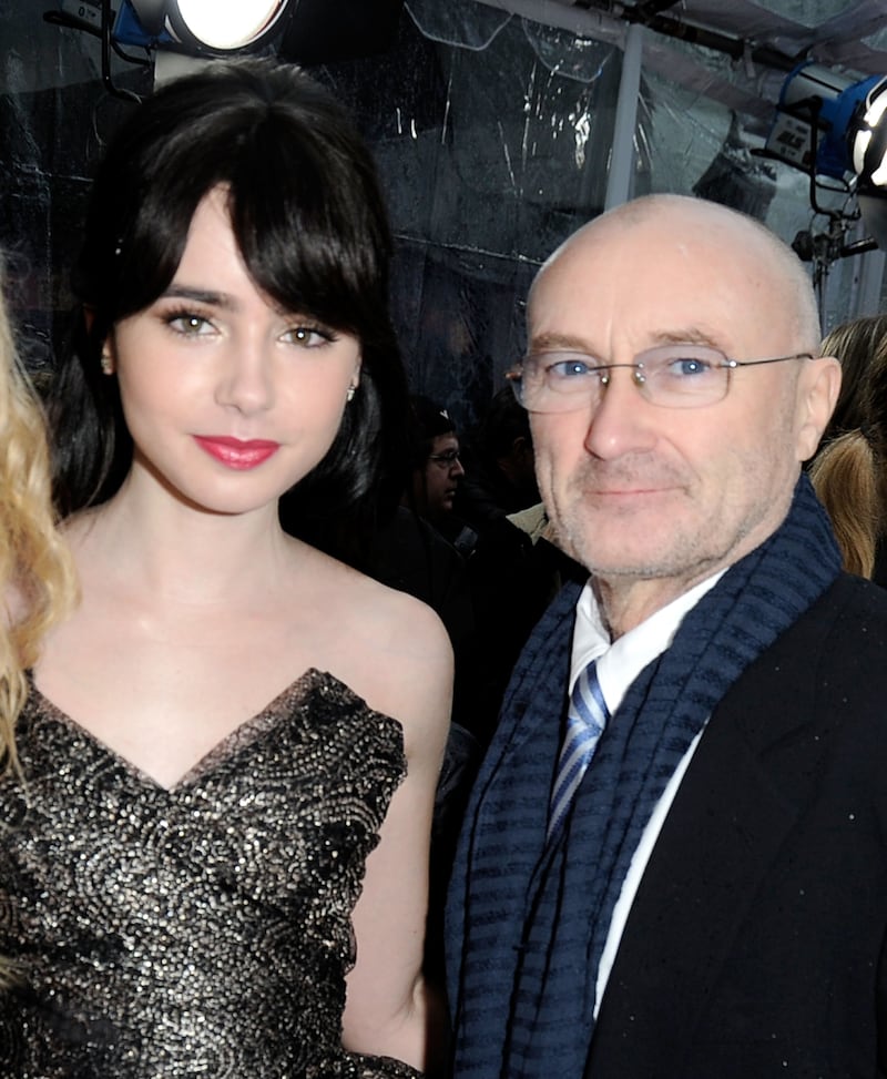 HOLLYWOOD, CA - MARCH 17: Actress Lily Collins (L) and musician Phil Collins arrive at Relativity Media's "Mirror Mirror" Los Angeles premiere at Grauman's Chinese Theatre on March 17, 2012 in Hollywood, California. (Photo by Frazer Harrison/Getty Images For Relativity Media)