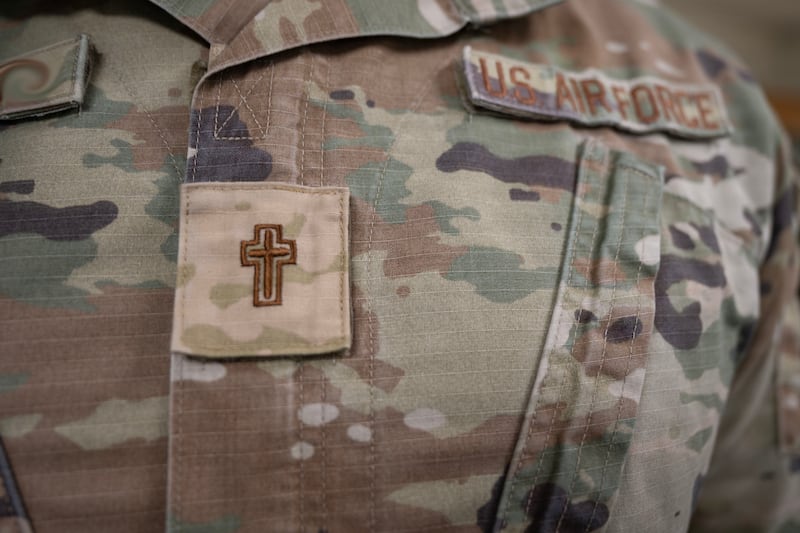 A chaplain assigned to the 1st Special Operations Wing wears a religious insignia on his chest at Hurlburt Field, Florida, Aug. 19, 2026. Under Department of the Air Force guidance, effective June 15, 2026, chaplains transitioned to wearing religious insignia instead of officer rank on their Operational Camouflage Pattern uniforms to remove visual barriers and increase approachability for Air Commandos. (U.S. Air Force photo by Ashton Hamby)