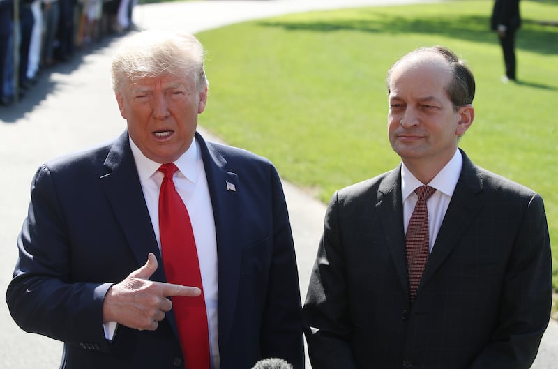 President Donald Trump stands with Labor Secretary Alex Acosta, who announced his resignation, while talking to the media at the White House on July 12, 2019 in Washington, DC.