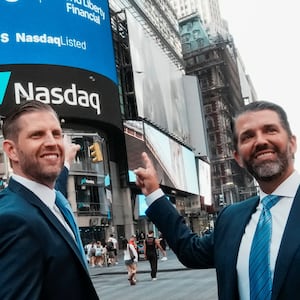 Donald Trump Jr. and Eric Trump pose for pictures outside the Nasdaq building after ringing the opening bell to celebrate the closing of ALT5’s $1.5 billion offering and adoption of its $WLFI Treasury Strategy at the Nasdaq Market, in New York City, U.S., August 13, 2025.  REUTERS/Eduardo Munoz