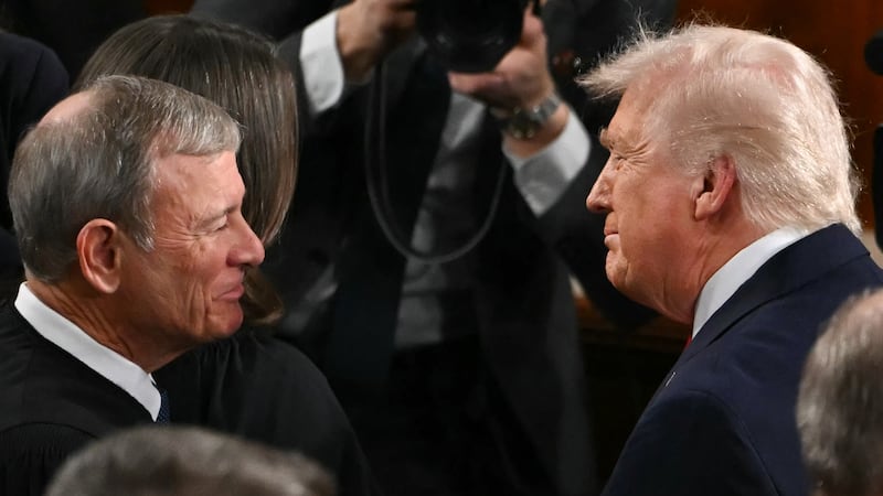 President Donald Trump shakes hands with Supreme Court Chief Justice John Roberts as he arrives to deliver his State of the Union address in the House Chamber of the US Capitol in Washington, DC, on February 24, 2026.