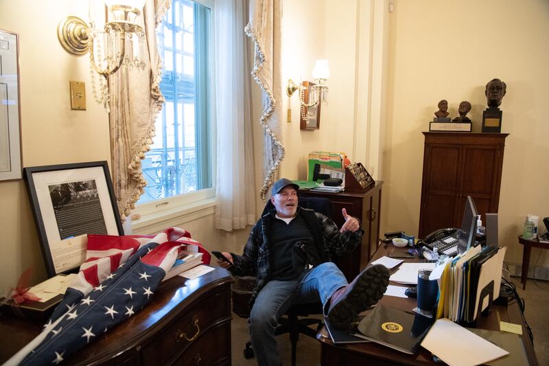 Richard Barnett, a Jan. 6 rioter sits inside Nancy Pelosi’s Capitol office during the attack.