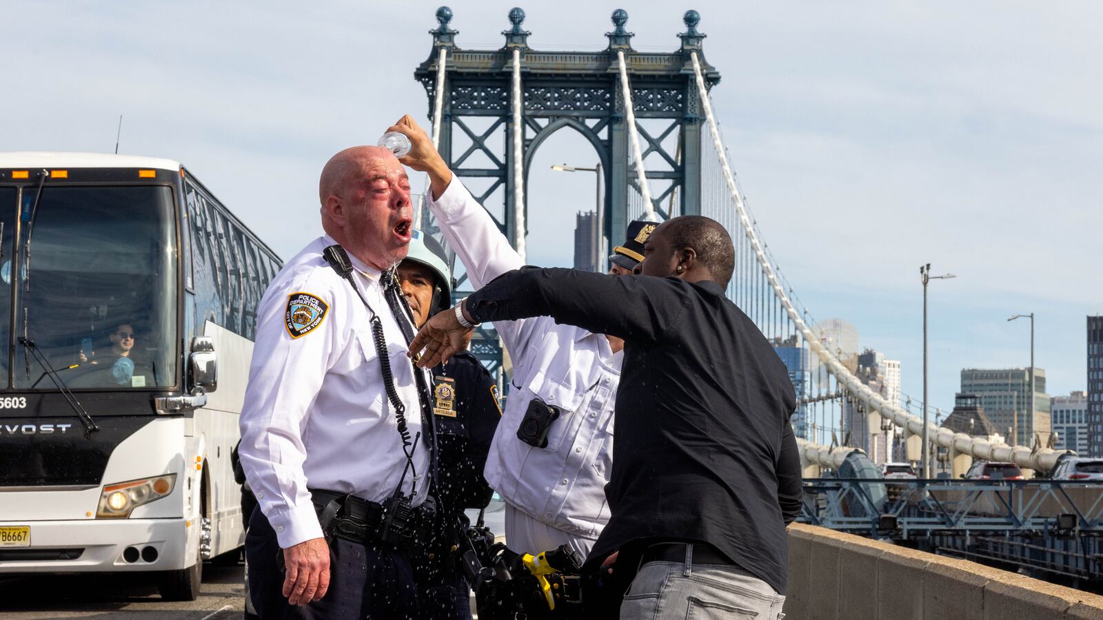 NYPD Assistant Chief James McCarthy is assisted after seemingly pepper spraying himself while police arrested pro-Palestinian demonstrators blocking traffic on the Manhattan Bridge in New York City.