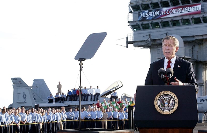 TOPSHOT - US President George W. Bush addresses the nation aboard the nuclear aircraft carrier USS Abraham Lincoln 01 May, 2003, as it sails for Naval Air Station North Island, San Diego, California. Bush declared major fighting over in Iraq, calling it "one victory in a war on terror" which he said would continue until terrorists are defeated. "In the Battle of Iraq, the United States and our allies have prevailed," Bush said. Bush touted Saddam Hussein's ouster as "a crucial advance" towards stamping out extremist violence.AFP Photo/Stephen JAFFE (Photo by STEPHEN JAFFE / AFP) (Photo by STEPHEN JAFFE/AFP via Getty Images)