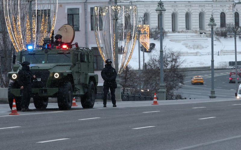 Armed officers of the Russian Federal Security Service patrol the bridge over the Moskva River opposite the Kremlin in a Tiger armored vehicle.